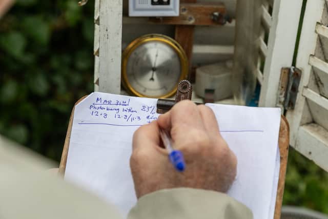 He uses a weather screen to note down the temperature, pressure and rainfall