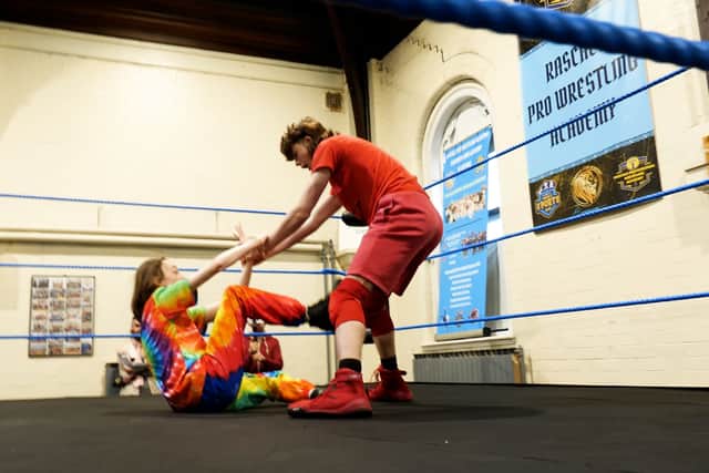 Rascals Academy wrestlers pick each other up