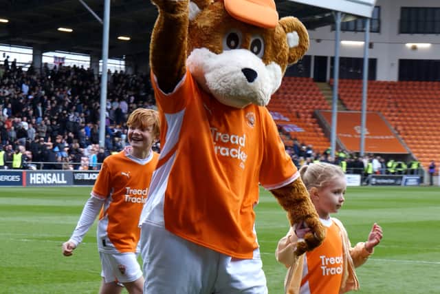 Bloomfield Bear has a kickabout with youngsters ahead of the Blackpool FC V Bolton Wanderers match.