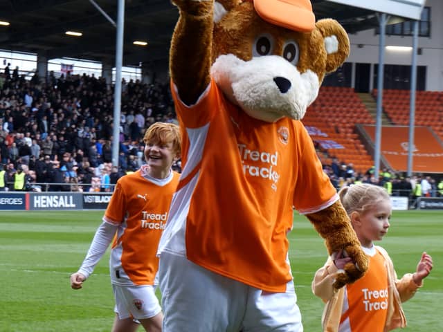 Bloomfield Bear has a kickabout with youngsters ahead of the Blackpool FC V Bolton Wanderers match.