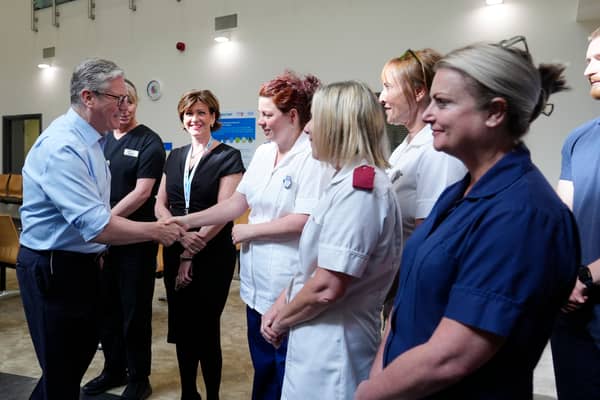 Prime Minister Sir Keir Starmer talks to staff during a visit to Rossendale Primary Health Care Centre 