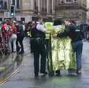 Police and emergency personnel dealing with an incident near the Liver Building in Liverpool during the Premier League winners parad