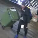 Reece Wheat drags the wheelie bin of stolen goods.
