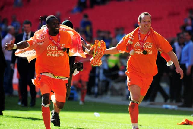 Jason Euell and Charlie Adam celebrate Blackpool's Championship play-off final victory against Cardiff in 2010.