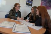 An Action Tutoring programme coordinator with two maths pupils 