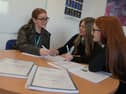 An Action Tutoring programme coordinator with two maths pupils 