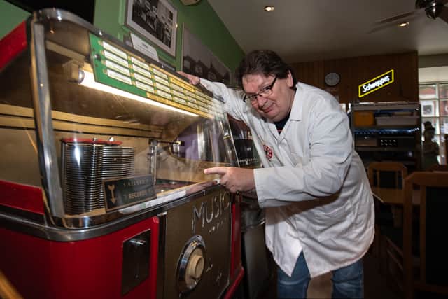 Karl Dawson with one of his restored Ditchburn Jukeboxes, in his St Anne's cafe. Photo by Lucinda Herbert.