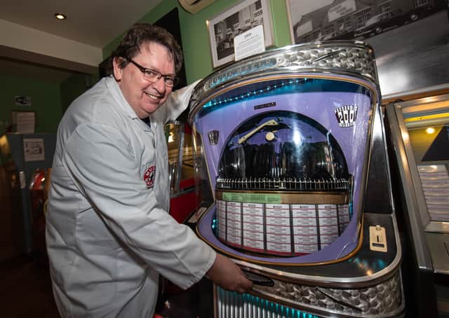 Karl Dawson with one of his Ditchburn Jukeboxes, restored to working condition and now in his museum/cafe in St Annes. Photo by Lucinda Herbert.