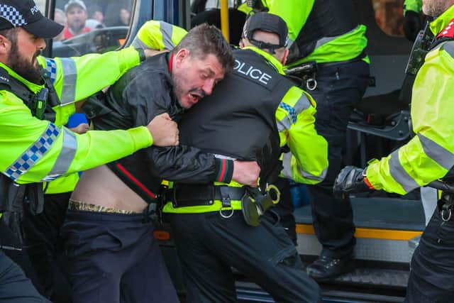 Police officers detaining a person during an anti-immigration protest in Blackpool in August 2024