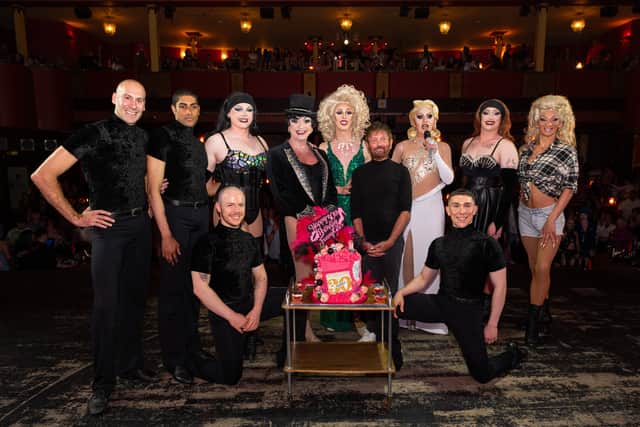 Performers and owner Basil Newby celebrate with a cake as Funny Girls in Blackpool celebrates 30 years