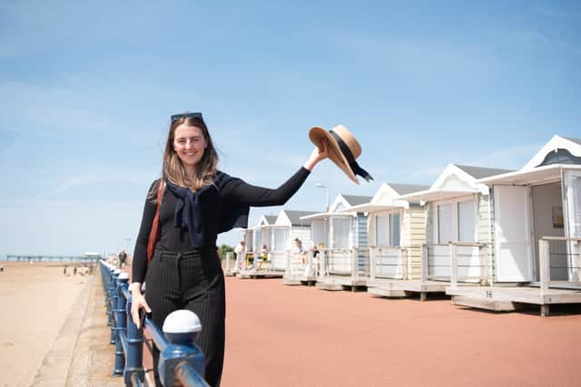 Reporter, Ciara Fearn, waves her straw sunhat during a day out at St Annes Beach Huts. Photo credit Lucinda Herbert