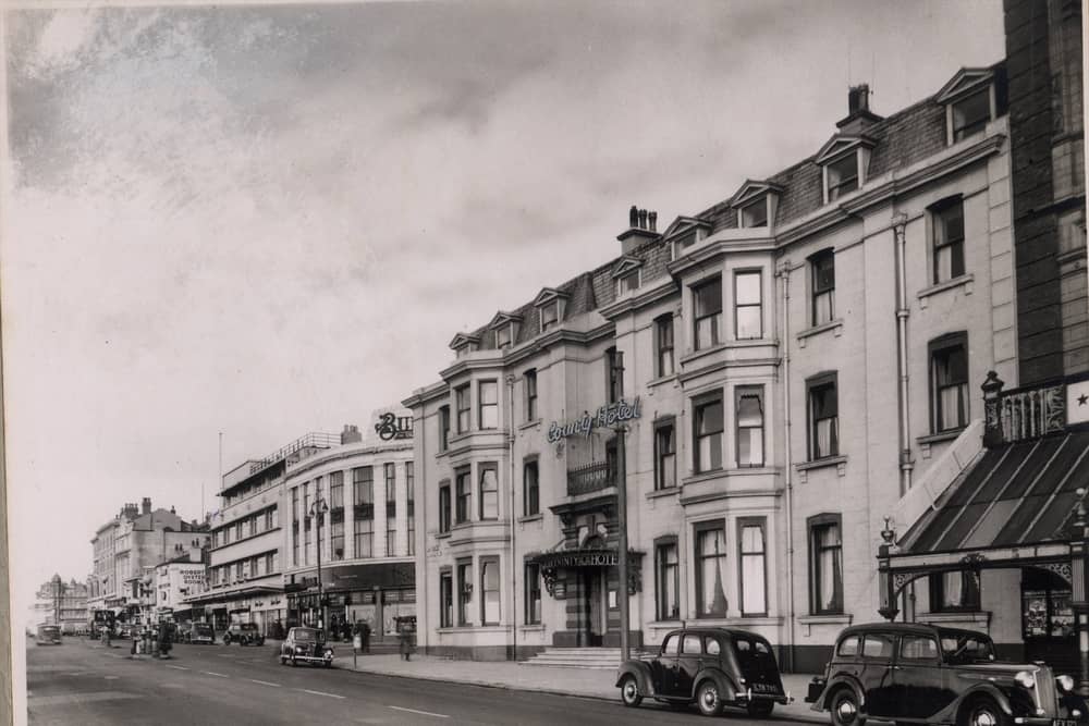County Hotel on the corner of the promenade and Church Street. To the right is part of the glass canopy of The Palace