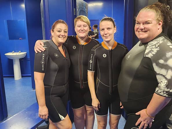 Colleagues at Blackpool home put their fears to one side as they snorkel with sharks and raise over £1400.