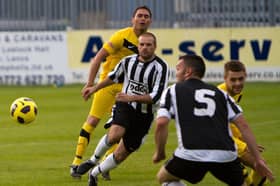 The late Paul Fiddler (centre) playing football