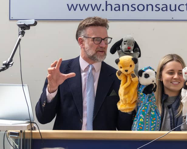 Charles Hanson with the puppets. TV auctioneer Charles Hanson had his hands full with three of the most famous glove puppets in the world, owned by the legendary puppeteer Harry Corbett. 