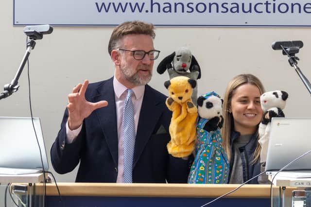 Charles Hanson with the puppets. TV auctioneer Charles Hanson had his hands full with three of the most famous glove puppets in the world, owned by the legendary puppeteer Harry Corbett. 