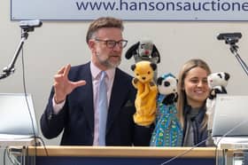 Charles Hanson with the puppets. TV auctioneer Charles Hanson had his hands full with three of the most famous glove puppets in the world, owned by the legendary puppeteer Harry Corbett. 