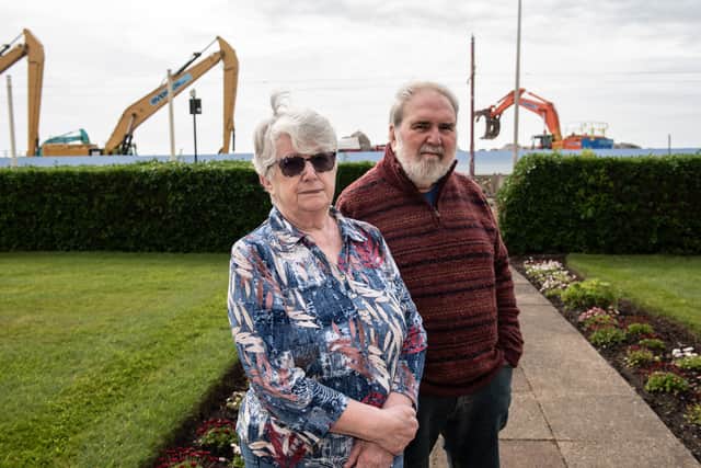 Frank and Dianne Mcknight lives opposite the compound where she describes workers start shifting boulders from before 7am, making constant noise and the compound has ruined their sea view. Photo: Lucinda Herbert