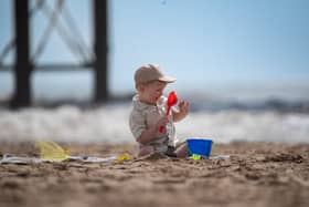 A youngster plays in the sand near Central Pier in Blackpool ahead of what promises to be a warm and sunny Bank Holiday weekend. Photo: Lucinda Herbert
