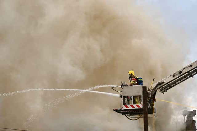 Firefighters responding to the major fire at the former Ex Catalogue store and M&S in Lord Street, Fleetwood. Huge flames and thick black smoke can be seen billowing across the town