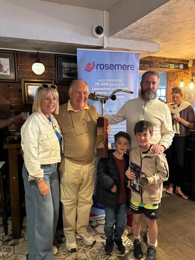 Maxi Moran (seven) is presented with his award for being this year’s youngest Taps rider by marshal Helen Kirkman, who helps husband Danny organise the annual charity bike ride. With Maxi is dad Dan, who rode alongside him, brother Ozzy (five) and grandad David Cam, who drove the cycle’s rescue van