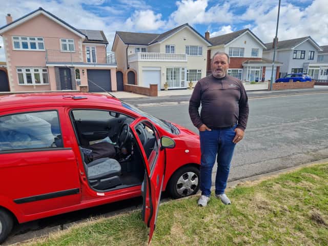 Michael next to his car