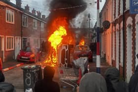 Vehicles set on fire by protesters on Lendrick Street in Belfast (PA)