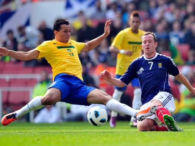 Scotland midfielder Charlie Adam, right, fights for the ball with Brazil's striker Leandro Damiao (L) during an international friendly football match in 2011. 