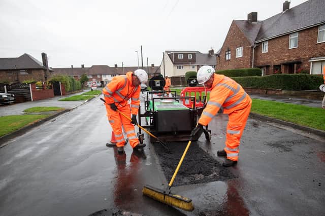 Workers repairing a pothole in Deepdale Road, Blackpool