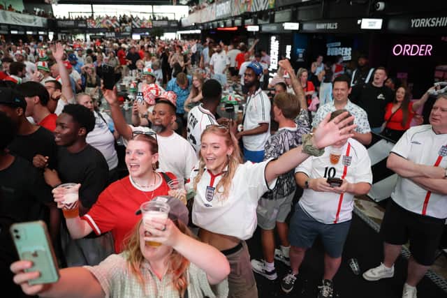 Fans watch a screening of the Fifa World Cup match between England and the DR of Congo.