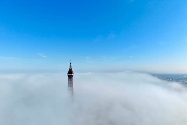 The Grade 1 listed Blackpool Tower peeks out from the clouds ahead of another scorching day at the northern seaside resort.