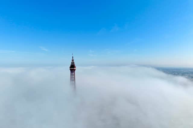 The Grade 1 listed Blackpool Tower peeks out from the clouds ahead of another scorching day at the northern seaside resort.