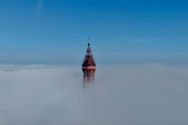 The Grade 1 listed Blackpool Tower peeks out from the clouds ahead of another scorching day at the northern seaside resort.