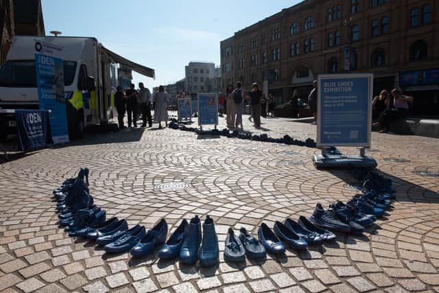 150 shoes have been painted blue in memory of each of the 150 people who have taken their own life due to domestic violence in 2025. Photo: Lucinda Herbert