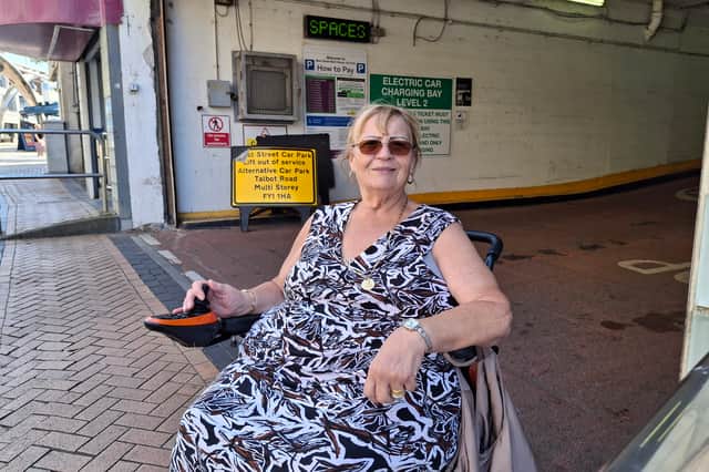 Dorothy Jones at West Street car park, with the lift closure warning sign behind her.