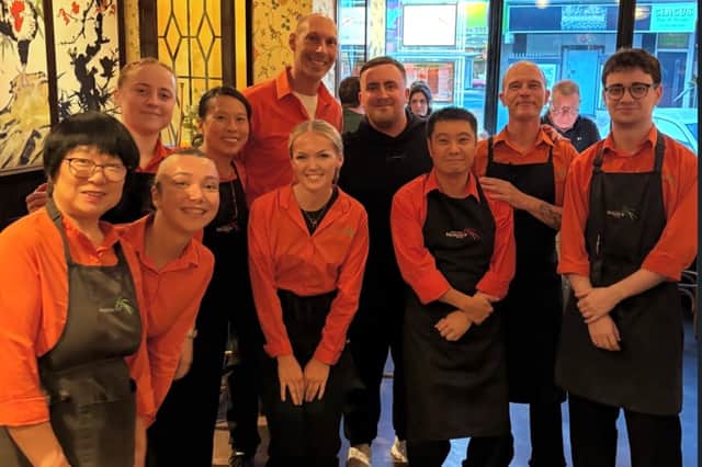 Darts star Luke Littler with staff at Michael Wan's Mandarin inside the restaurant last night.