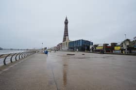 The Blackpool Tower’s reflection can be seen on a wet promenade (Peter Byrne/PA)