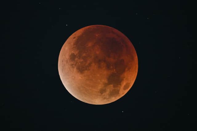 The blood Moon is pictured during an eclipse in the night sky in Shanghai on 8 September 2025.