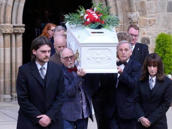 Jimmy Cricket's coffin is carried into the funeral ceremony.
