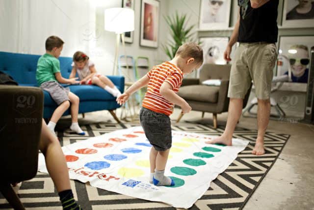 stock-photo-night-activity-family-game-home-play-kids-twister-silly-0bb400c0-9399-4f6c-a3d0-2b0c58d9b473