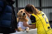 Fylde's Chelsey Jukes celebrates their latest win with her biggest supporter, Stan 