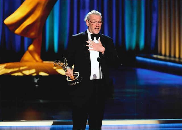Hamish Hamilton collecting an Emmy award.