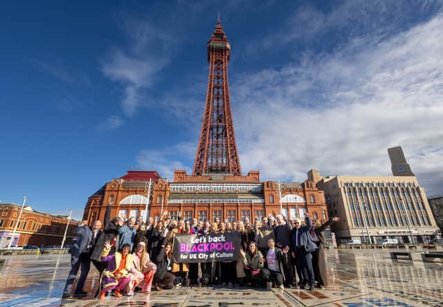A collection of the people involved in Blackpool's City of Culture bid celebrate making the final four short on the Comedy Carpet