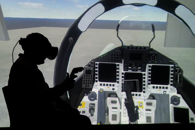 Pictured is reporter Will Atherton trying out the VR headset which is used by the Demonstrator team.