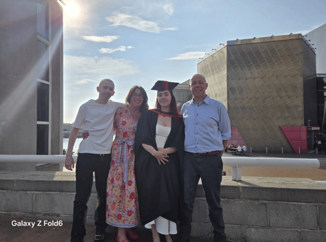 Stanley pictured with mum Jane and dad Ian at his sister Olivia's graduation.