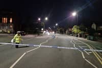 Wigan Lane this evening. A damaged motorbike remains in the middle of the road