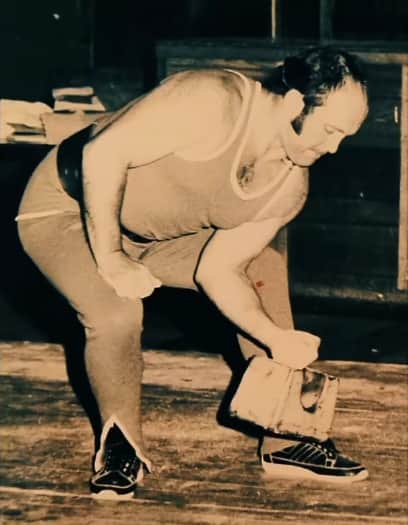 Harry Kay lifting a 56lb weight with his little finger