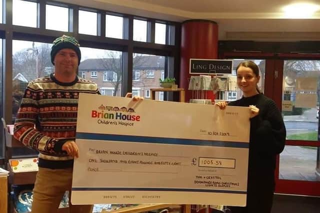 Tim Holloway presents his cheque for 1008.58 to Brian House after his 2018 Christmas lights switch-on.
