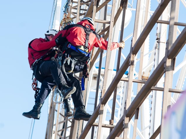 Firefighters bringing down the stranded man using a rope system (Picture: Kelvin Stuttard/JPIMedia)
