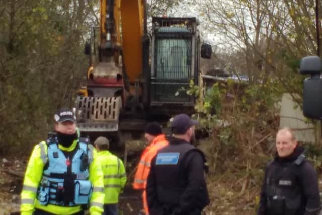 Heavy equipment goes in to demolish shelters